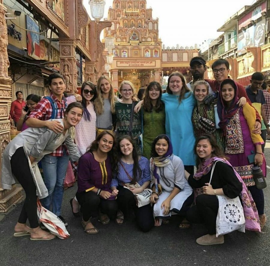Faith Anderson poses with other students in the market in India
