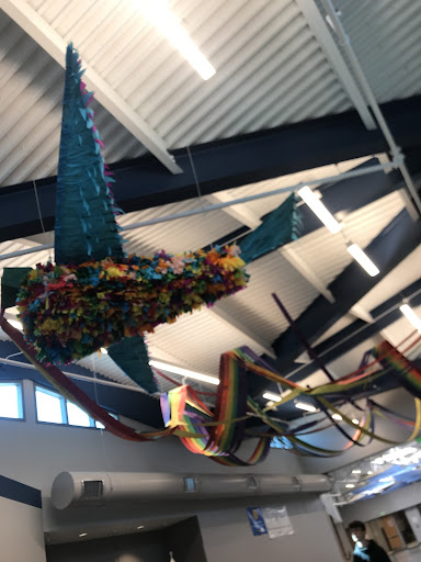 Rainbow streamers, hung up on the ceiling with students messages on them.